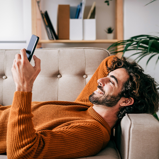 man-couch-phone-happy-1-1-544x544px